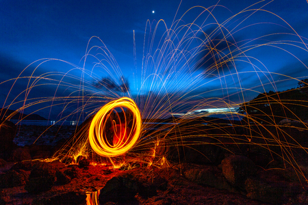 Cool Burning Steel Wool Photo Experiments.burning steel wool spinning circle Fire at sunrise.の写真素材
