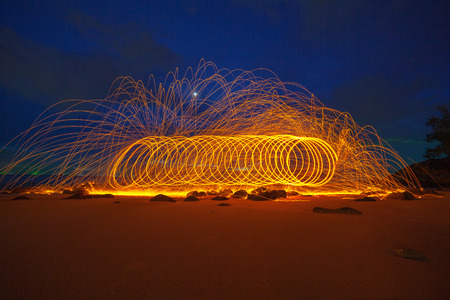 cool burning steel wool art fire work photo experiments on the beach at sunset