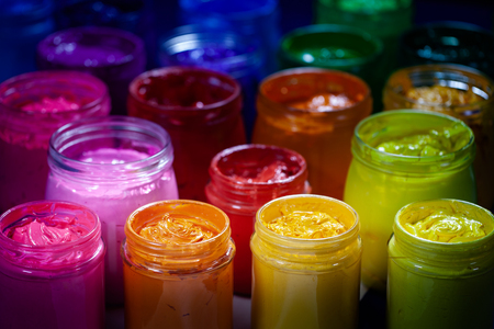 pink orange and yellow colors of screen printing ink for print on tee shirts and fabric. plastisol ink useful in tee shirt factory and textile for exporの写真素材