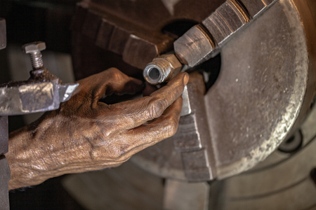 a hand of worker inside factory to build and repair shipの写真素材