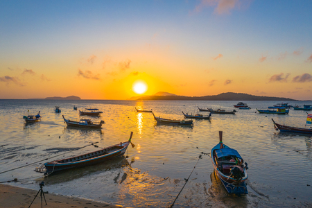 yellow sky during sunrise above fishing boats in Rawai sea Phuket Thailandのeditorial素材