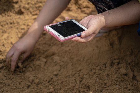 Thai people and farmers search for rice seeds at The Royal Ploughing Ceremony DayIn order to be a...