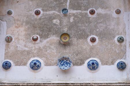 beautiful Chinaware bowls decorated on the wall of church at wat Ban Lang temple in Rayong province Thailand. the old church was built in Ayutthaya periodの写真素材