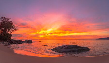 stunning red sky at sunset over the sea at Karon beach Phuket Thailandの写真素材