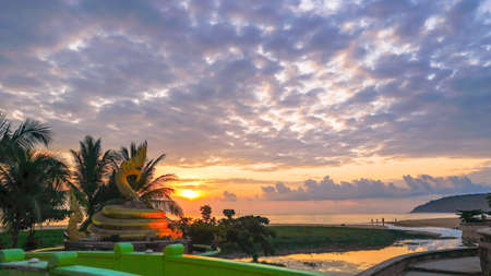 
sunset behind golden dragon statue on Karon beach Phuket Thailandのeditorial素材