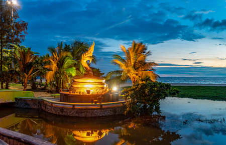reflection of the golden serpent statue at Karon beach Phuket Thailand.のeditorial素材