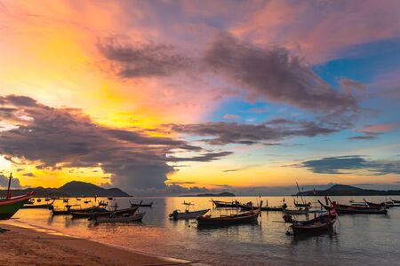 beautiful sunrise above fishing boats on Rawai beach, Phuket,Thailand.の写真素材
