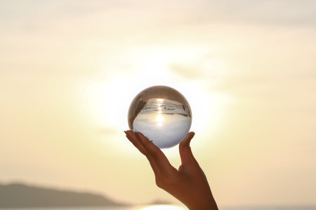 lady catch the crystal ball on her hand beside Patong beach during sunset