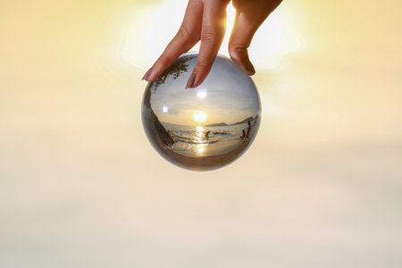 lady catch the crystal ball on her hand beside Patong beach during sunset