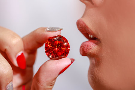 A lady Use your fingers to hold the red ruby diamond close to her lip