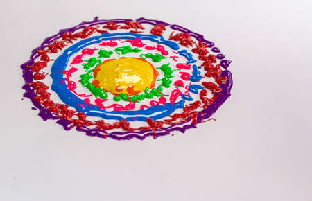Colors drop onto a spinning white background. The color of the drops is a circular haloの写真素材
