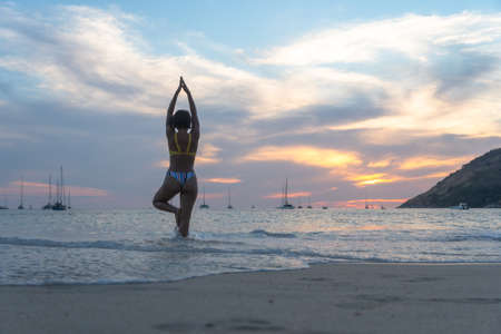 lady acting in scenery sunset on the beach.の写真素材