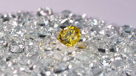Yellow diamonds are placed on a pile of white diamonds And keep turning.の写真素材