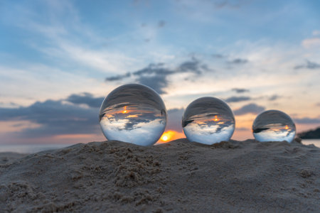Three clear crystal balls of three sizes are sphere reveals  seascape view with spherical placed on...