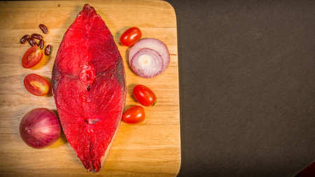Preparing cooking materials. Fresh vegetables,Fresh fish fillets and spices are placed on a...