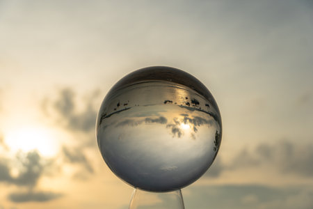 view of the sea and sky inside crystal ball. The natural view of the sea and sky are unconventional and beautiful. 
A image for a unique and creative travel idea.の写真素材