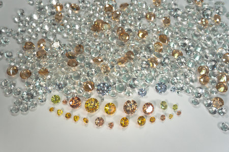 A group of Golden diamonds arranged in a row in front of white diamonds on a white background.の写真素材