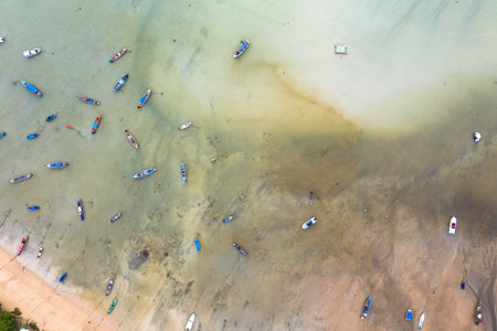 aerial top view fishing boats parking on the beach during low tide at Rawai beach Phuket...