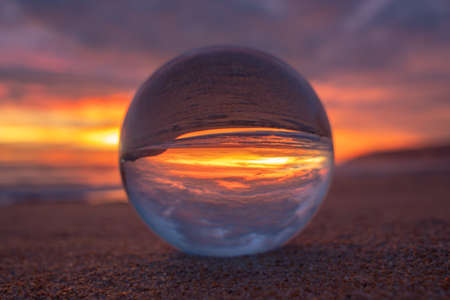 view of beautiful sky at sunset inside crystal ball.
The natural view of the sea and sky in beautiful sunset are unconventional and beautiful inside crystal ball.の写真素材