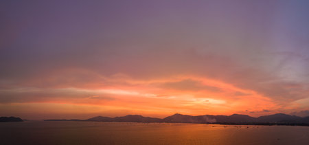 aerial view stunning sky in sunset above the sea.colorful cloud in bright sky of sunset above the ocean at Khao Khad Phuket. Majestic sunset or sunrise landscape Amazing light of nature background.の写真素材