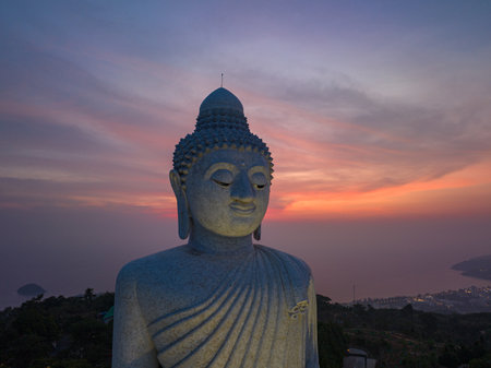 aerial view Phuket big Buddha in beautiful sunset.the sun shines through the clouds impact on ocean surfaceThe beauty of the statue fits perfectly with the charming nature.cloud scape background.の写真素材