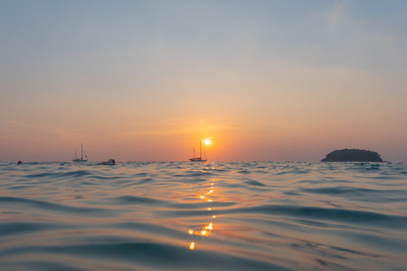 scenery reflection of the sun in golden sky at sunset. 
bright yellow sky in the beautiful evening.
Scene of Colorful romantic sky sunset with gold color of the sky background.の写真素材
