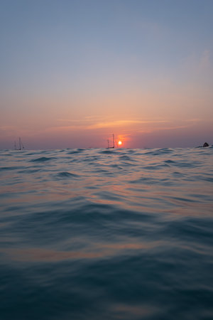 scenery reflection of the sun in golden sky at sunset. bright yellow sky in the beautiful...