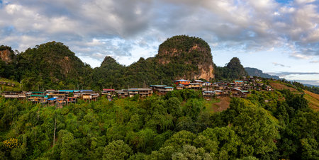 Amazing aerial view of the sunrise over a small mountain village landscape, mountains in the background, a ravine in the foreground with a sea of ââmist, a peaceful atmosphere and natural beauty.の写真素材