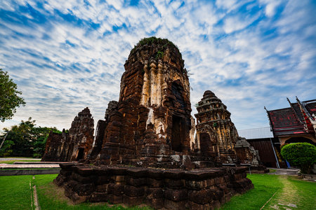 beautiful wavy cloud pattern above the Wat Kamphaeng Laeng temple in the sky. The ancient temple is surrounded by a wall made of huge sandstone blocks, most of which is still standing.の写真素材