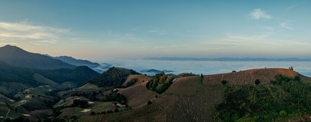 Aerial view of Rays of light burst from the mountain peaks in the morning.The beautiful sunrise...