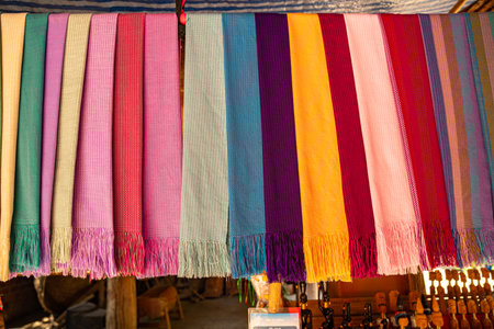 A vibrant display of traditional handwoven fabrics featuring an array of bold and rich colors with intricate patterns. the craftsmanship and cultural heritage of weaving traditions in the northの写真素材