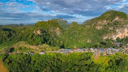 Amazing aerial view of the sunrise over a small mountain village landscape, mountains in the background, a ravine in the foreground with a sea of ââmist, a peaceful atmosphere and natural beauty.の写真素材