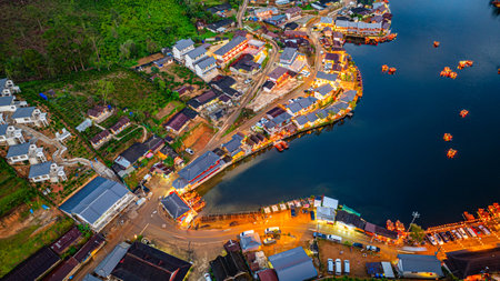Baan Rak Thai Village at sunset reflections of houses and restaurants along the lake in Chinese-style architecture with colorful lights line the water. a popular tourist attraction in Mae Hong Sonの写真素材