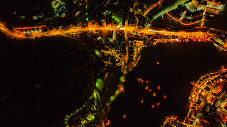 Baan Rak Thai Village at sunset reflections of houses and restaurants along the lake in Chinese-style architecture with colorful lights line the water. a popular tourist attraction in Mae Hong Sonの写真素材