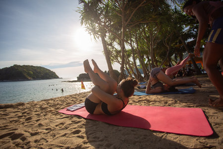 Group of women practicing yoga on the beach
Yanui is a small, quiet beach with blue sea and a small island in front that is a beautiful sunset viewpoint near Promthep Cape and Nai Harn Beach.の写真素材