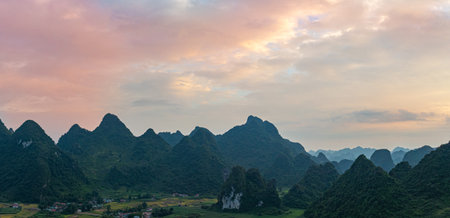 A breathtaking aerial view of a dramatic sunrise illuminating the sky with vibrant orange and red...