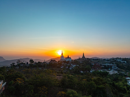 Aerial view beautiful golden pavilion at Wat Phachonkeaw at sunrise.
5 sitting buddha statues of Phachonkeaw on Khao Kho hill the beautiful landmark 
and famous in Phetchabun Thailandの写真素材