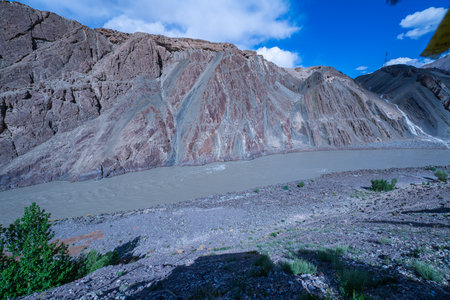 Sangam Point is The confluence of the Indus and Zanskar rivers has two different colors of water between Kargil and Leh, India. landscape with a  river winding through a deep valley.の写真素材