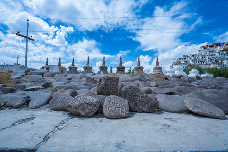 Ladakh,India-May,23,2025: Tibetan prayer stones and view on Thiksey monastery, Ladakh, one of more interesting objects in the Indus valley in Leh District, India. row of stupas near Thiksey monasteryの写真素材