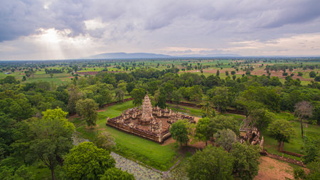 Aerial view of Sadok kok thom Castle an ancient Khmer-style nestled within a verdant forest, showcasing intricate stone architecture and historical design elements surrounded by natural greenery.の写真素材