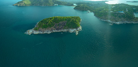 Aerial view Man island is in front of Phrom Thep. The sky is filled with blue clouds in the morning.Blue clouds roll over the sea.Tourist attractions that are gathered together near Man isleの写真素材
