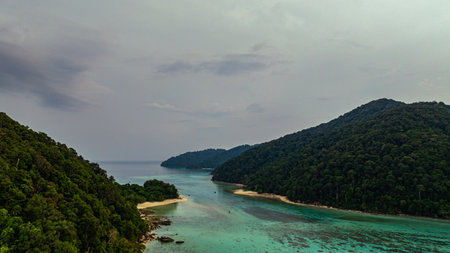A stunning aerial view of lush green tropical islands surrounded by crystal-clear turquoise waters....