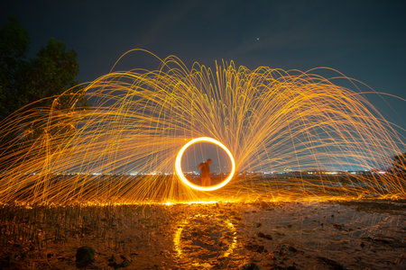 reflection of spark fire swirl from steel wool with long exposure speed motion abstract at twilight...