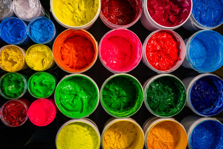 Colorful Ink for Screen Printing Factories
Inside a busy Tee shirt factory plastisol inks in multiple tones bright and dark are neatly arranged for industrial use. Workers use handmade tools handlesの写真素材