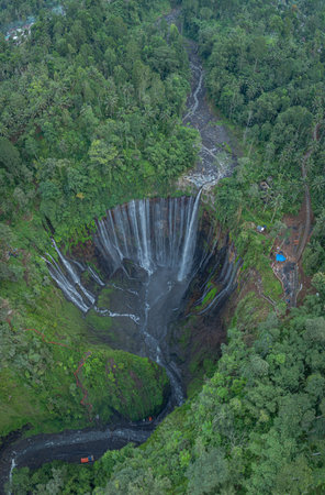 Amazing aerial view Many streams of water flow down in all directions and fall at Tumpak Sewu Waterfall. The waterfalls falling from the semicircular cliffs at Tumpak Sewu are unusually beautiful.の写真素材