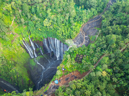 Aerial view Tumpak Sewu Waterfall. The hills and mountains in Java are full of amazing waterfalls. Thousands of waterfalls flow together at Tumpak Sewu. green forestの写真素材