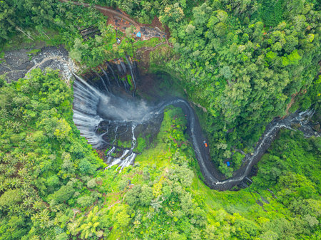 Aerial view Tumpak Sewu Waterfall. The hills and mountains in Java are full of amazing waterfalls. Thousands of waterfalls flow together at Tumpak Sewu. green forestの写真素材