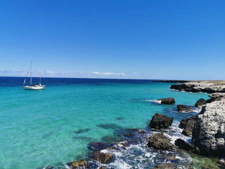 sailing boat in the crystal clear seaの写真素材