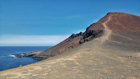 A volcano overlooking the sea in Lanzaroteの写真素材