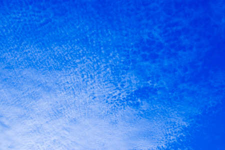 white fluffy clouds in the blue sky の写真素材